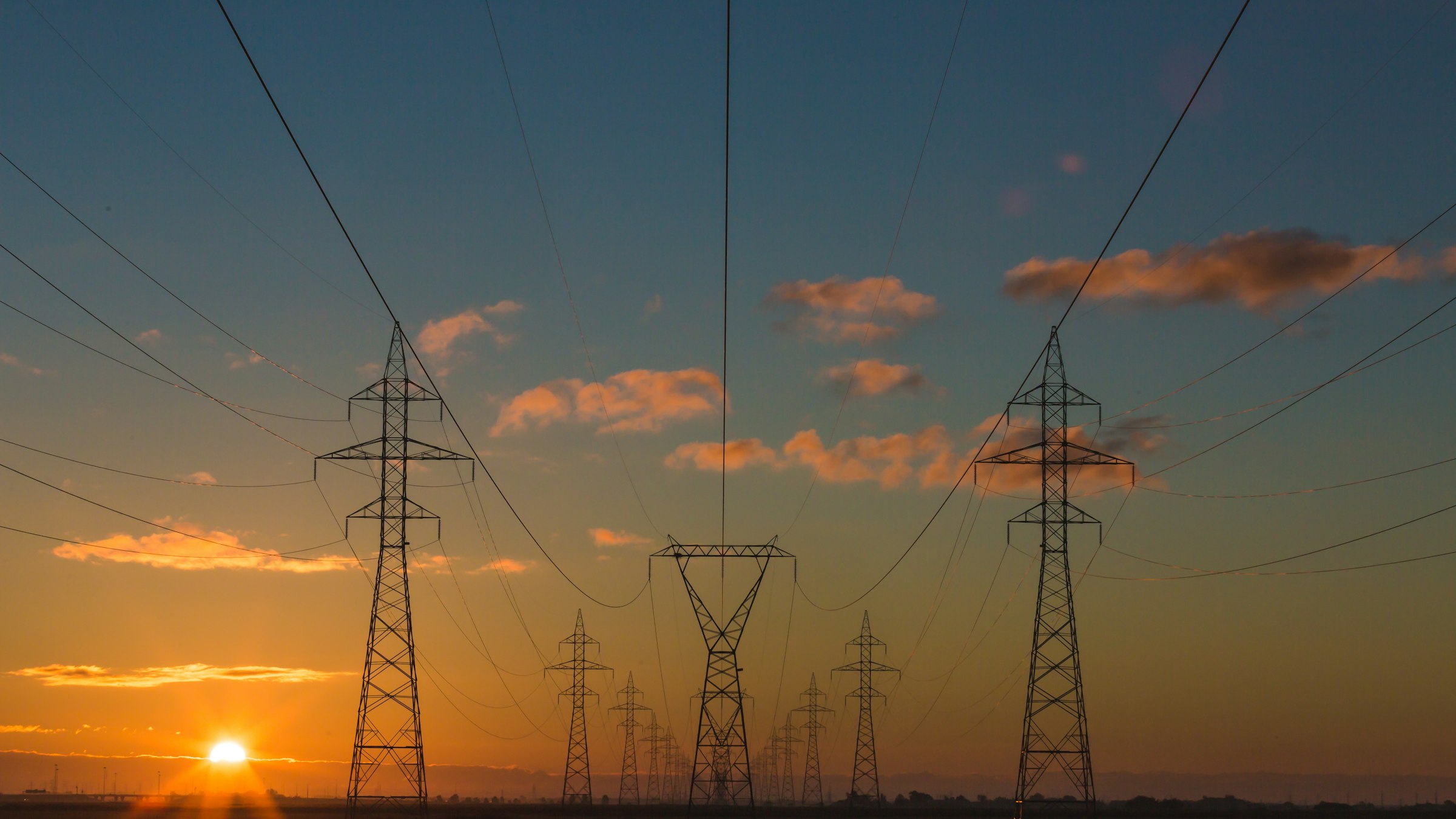High-voltage transmission towers at dusk
